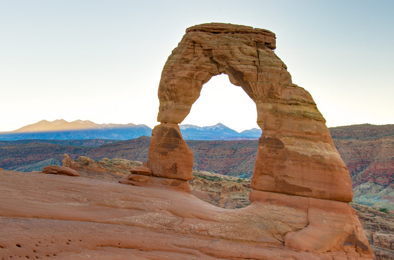 Delicate Arch at sunrise with La Sal Mountains