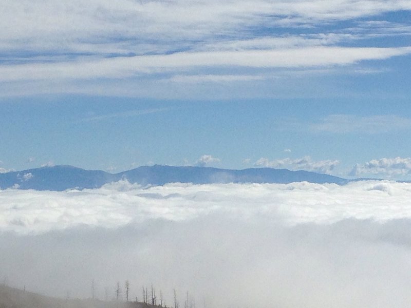 Low clouds fill the valley between Jemez and the Sangre de Christo Mountains.  You can see Santa Fe Baldy and Lake Peak side-by-side.