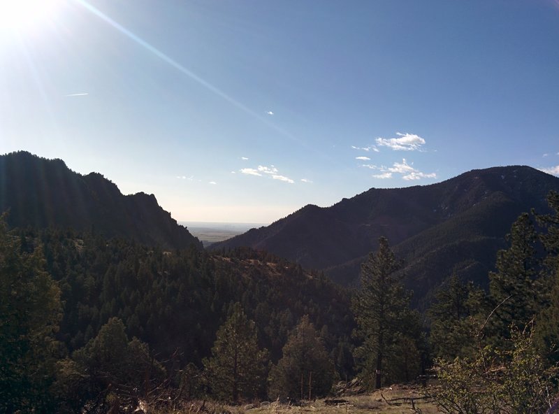 Looking southeast towards Denver. from the Eldorado Canyon Trail  Denver skyline visible through the haze in the "V" of the mountains.