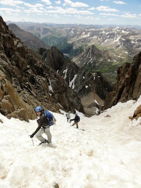 Hikers descending the gully, not far from the summit. The 13,500 ft saddle can be seen in the distance.