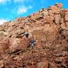 This photo, taken to the left of the ridge on Mt. Eolus, gives some idea of the loose, scrambly terrain on this route and its grassy ledges.