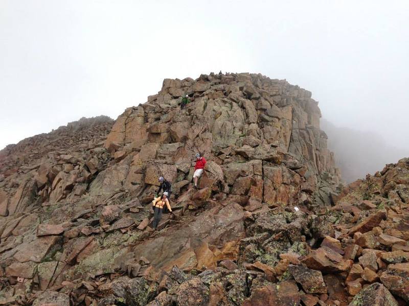 Just above the gully, a look at the standard scrambling along Sunlight Peak's standard route.