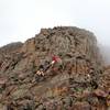 Just above the gully, a look at the standard scrambling along Sunlight Peak's standard route.