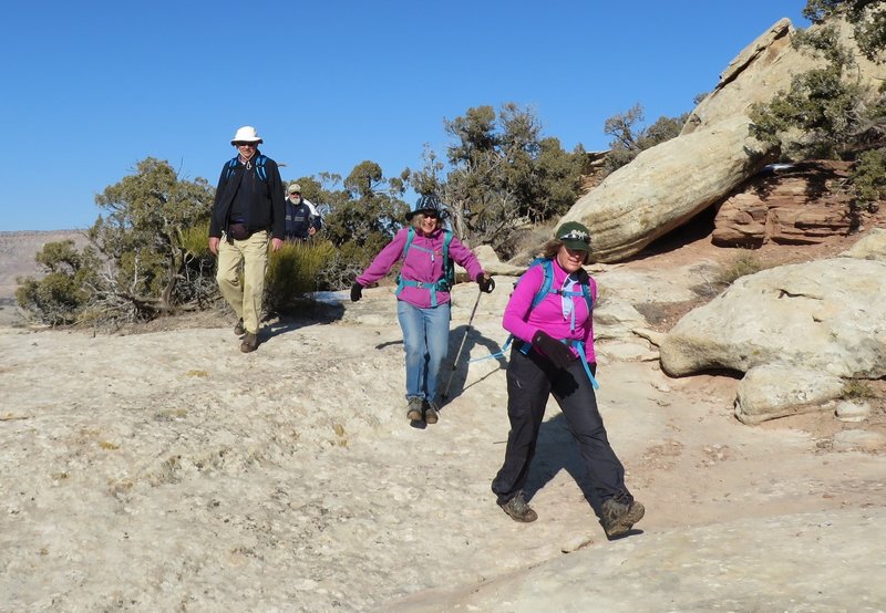 Hiking across slick rock. Just watch for cairns to find the next segment of trail.