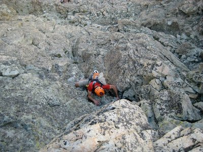 A climber works his way up the class 4 crack of the crux wall.