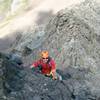 A climber on the start of the crux wall, just below the crack in the next picture. Easier scrambling can be seen behind him.