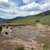 The 2013 flood took out this section of trail.  As of spring 2015 you still have to take off your shoes and wade through.