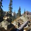 A few rock cairns along the way. Red mountain in the background.