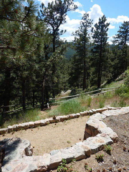 The start of the Prairie Overlook Trail is just south past this "notch" in the ramp wall.  Cross the wood fence and head southwest along a faint trail that gradually becomes more visible.  See cairns in this picture.