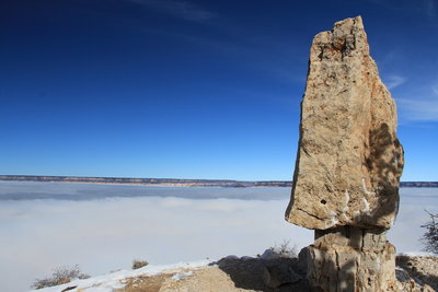 Tombstone rock on Shoshone Point with inversion cloud layer in the canyon