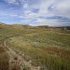 Epic singletrack of the Maah Daah Hey trail winding through the painted hills of the badlands.