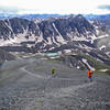 Runners descending Handies Peak towards Sloan Lake. Grouse gulch is the next aid station. American Peak is the mountain in the backdrop.