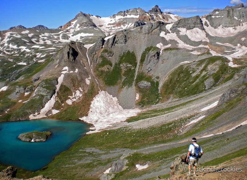 Descending Grant/Swamp Pass to Ice Lakes Basin. Island Lake, is below and Fuller Peak, Vermillion Peak and Golden Horn stand tall in the distance.