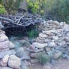 The rock foundation marking the trail's entry into the denser forest of the canyon.