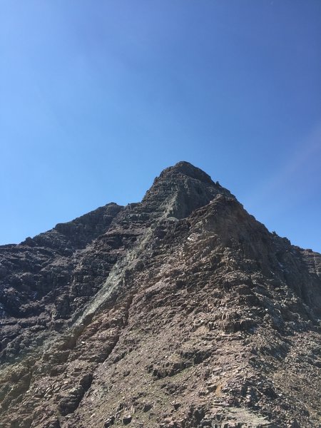 Most of the route is visible from the saddle at 13K. The light green rock composing a rib from the summit, AKA the "green gully" is a major route finding landmark.