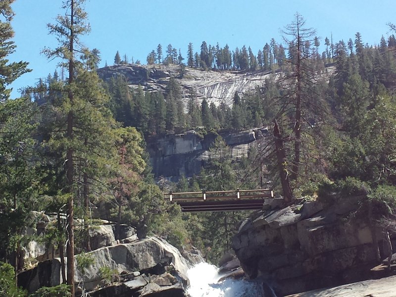 The railings let you go as close to the edge as the edge, but will your nerves allow it? Looking at the bridge over Nevada Falls.