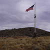 Flag flying among ruins at Fort Bowie.