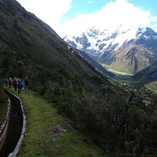 A view of Salkantay Mountain while walking the trail. The Incan irrigation system can be seen to the left.