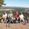 Hikers enjoying the bench with the view at the top of Pine Bluff.  Spokane River in the distance.