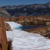 Red rocks and snow mingle on Red Peak Pass.