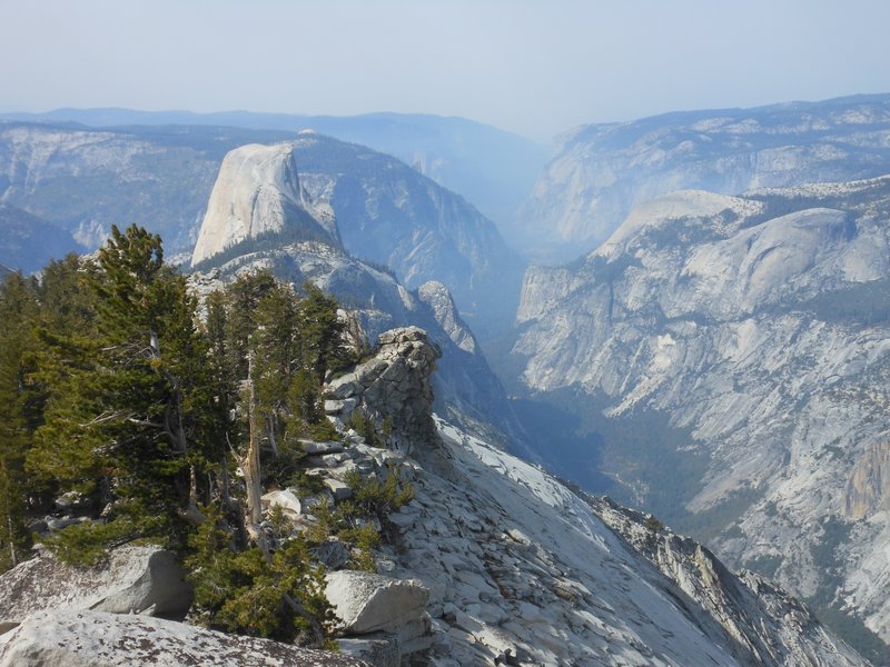 Westward view of Yosemite Valley, Half Dome, Tenaya Canyon, and smoke from fires from Clouds Rest.