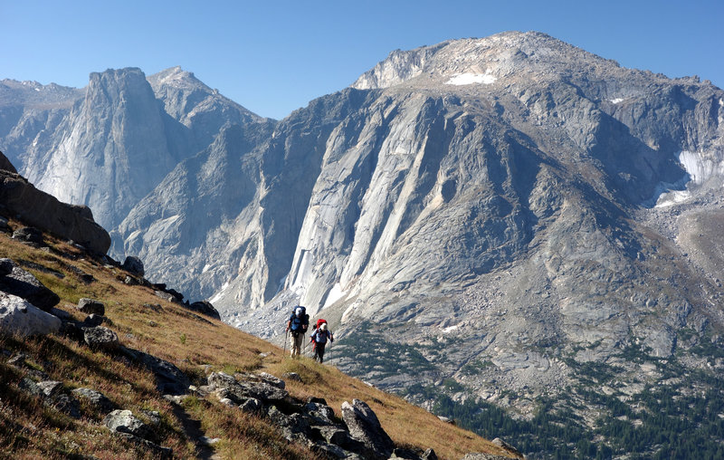 A group of hikers ascends the Lizard Head Trail with Lizard Head Peak in the distance.
