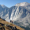 A group of hikers ascends the Lizard Head Trail with Lizard Head Peak in the distance.