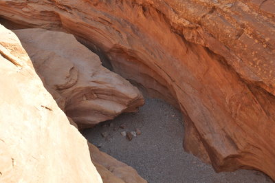 From the left side, looking down on the boulder blocking the entrance.
