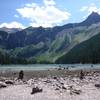 Avalanche Lake in July, with low water but no shortage of stunning angles on the distant waterfalls. The beach is rocky, but it's a great reward at the top of the hike, and you can walk around the lake.