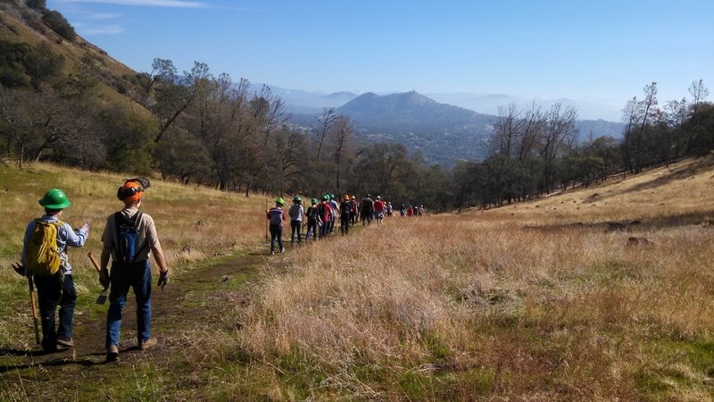 Volunteers and staff out working on the trail. View is East towards Prather and the Kings River watershed.