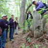 Hikers check out a tree stump during the annual May Rhodo Ramble.