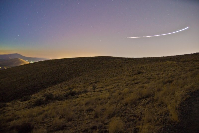 The Skyline Trail is even spectacular after the sun goes down, as subdivision glow illuminates the horizon, while a comet streaks past.