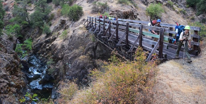 A trail crew crosses over Mule Creek.