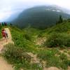 Family hiking downhill from Iceberg Lake.