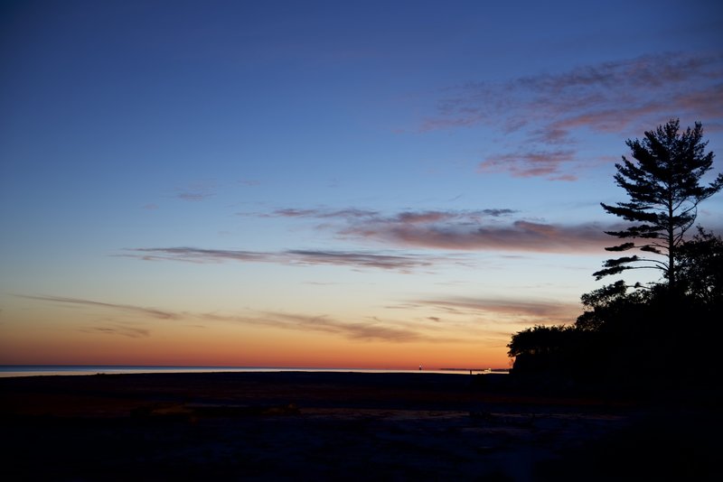 Incredible sunrise on Lake Michigan. The Michigan City lighthouse is in the distance. Taken just east of the Lakeview parking lot.