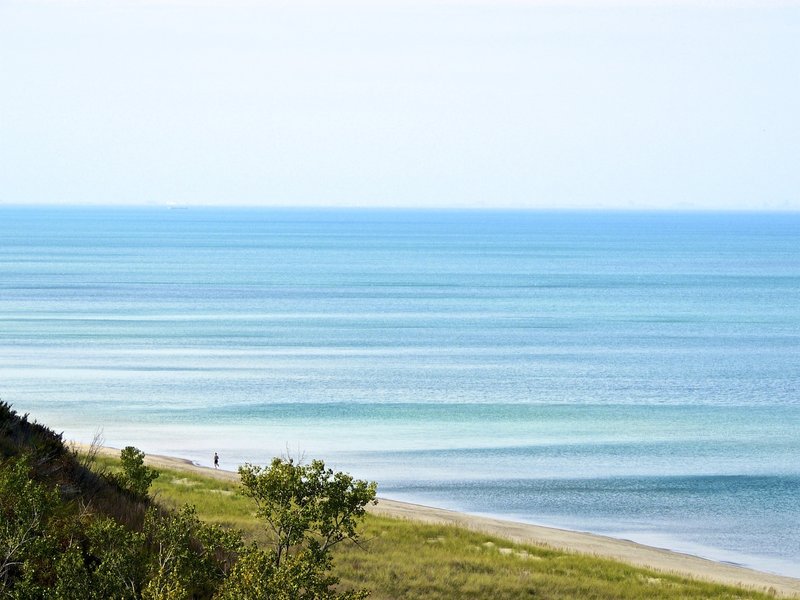 A lone jogger on the beach.