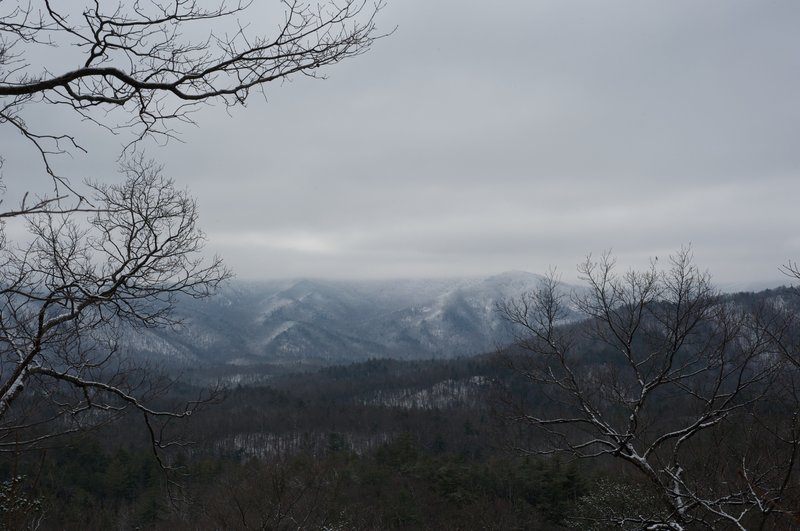 There are clearings along the trail that open up and the crest of the Smokies are visible on clear days. Here, snow covers the crest.