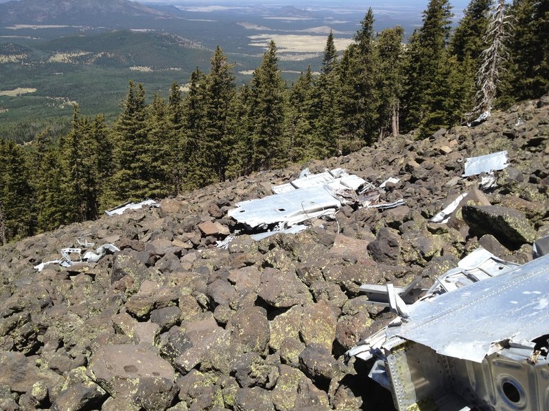 B-24 wreckage on steep rocky slope.