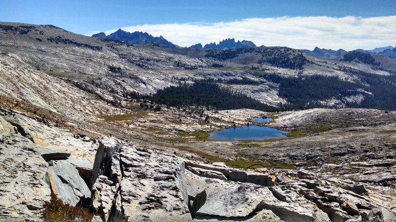 View east from Isberg Pass of the Ritter Range and the Minarets peaking up over the ridge.