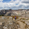 Hiker and Mica Lake along trail descending from Paintbrush Divide.