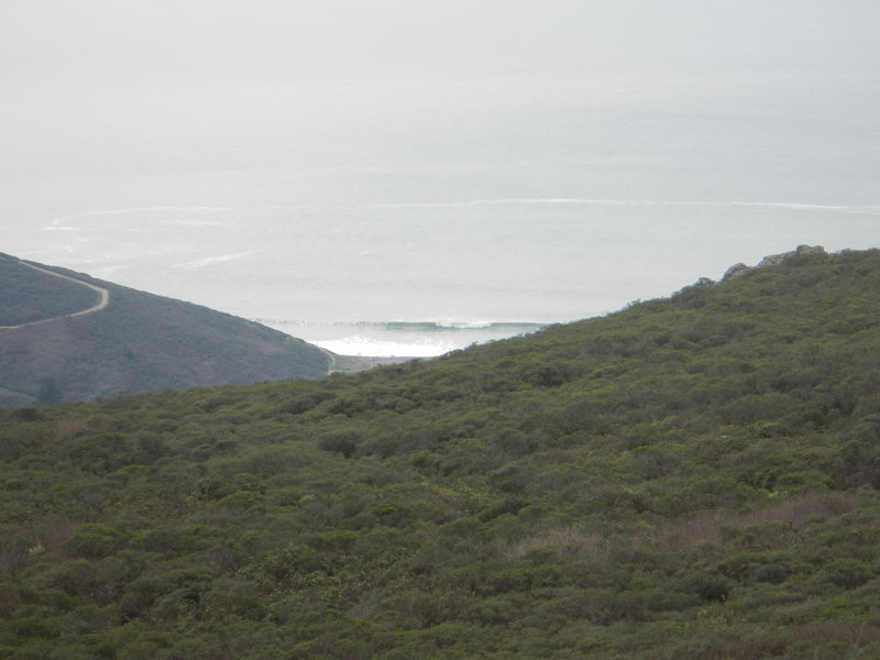 View from the top looking at surfers scrambling to get over this set wave at Muir Beach.