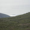 View from the top looking at surfers scrambling to get over this set wave at Muir Beach.