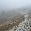 Fog drifts over the trail approaching Cathedral Pass.