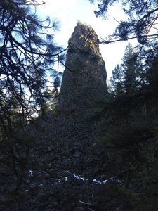 A large geologic formation rising above the trail!