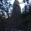 A large geologic formation rising above the trail!