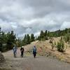 Hikers returning from a rewarding trip to the top of Mount Washburn (the Washburn Fire Lookout is visible on the upper right).