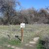 Post and trail map at the east end of the Red Tail Trail.