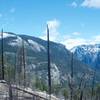 The view toward Yosemite Valley. El Capitan peeks above the ridge line, and Bridalveil Falls can be seen on right hand side.