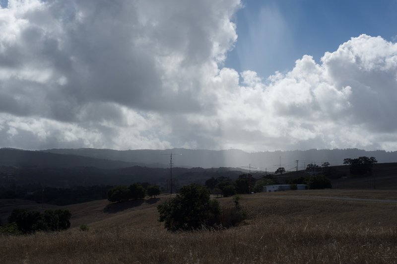 The sun breaks through the clouds on a stormy afternoon. The surrounding hillsides make it easy to forget you are in the middle of Silicon Valley.