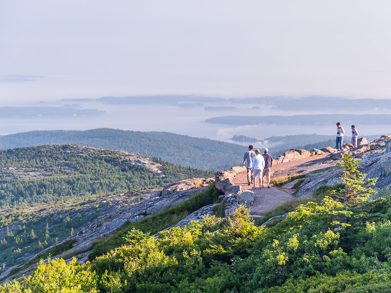 Hiking the Cadillac Summit Trail with views of the Cranberry Isles in the distance.